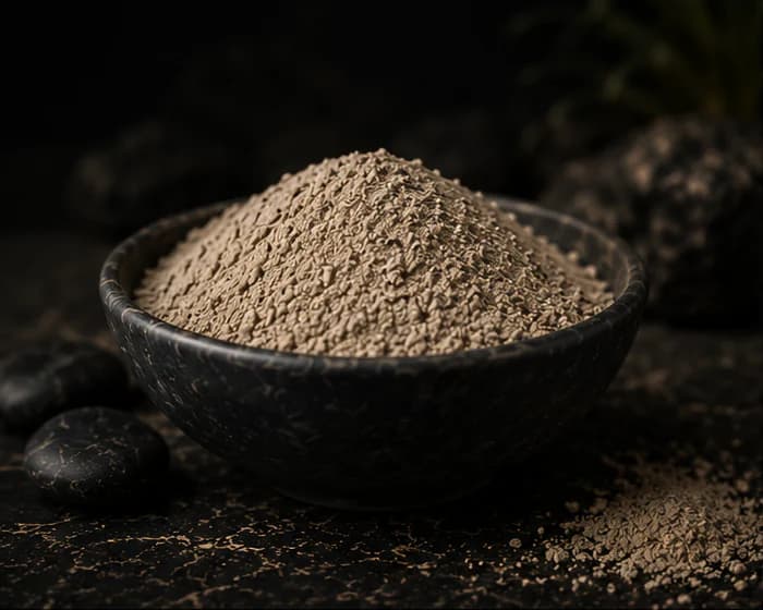 Beige Low Tide mineral-botanical mixture in a dark stone bowl